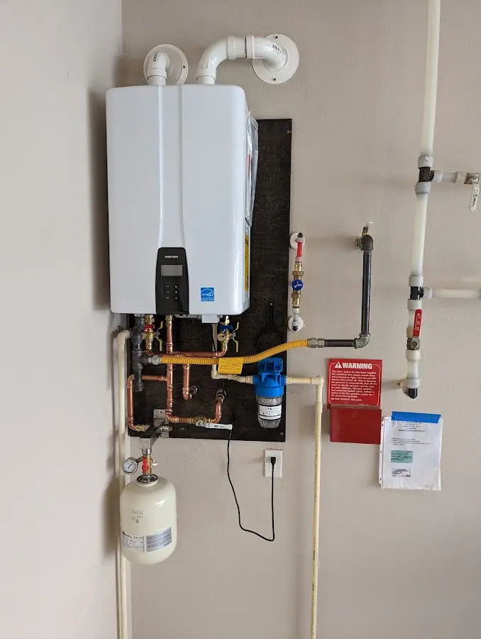 Professional plumber installing copper piping in a Hunter home